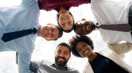 High angle view of diverse businesspeople standing in circle and looking at cameraの素材