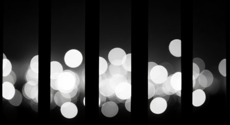 A striking black and white abstract image featuring out-of-focus bokeh lights, creating a soft, glowing effect. Vertical dark bars segment the frame, adding a structured contrast to the ethereal circles of light. The composition evokes a sense of mystery and modern design.の素材
