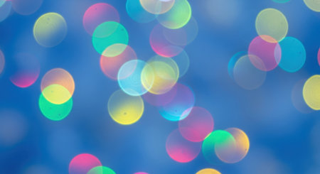 A vibrant abstract background featuring soft, out-of-focus bokeh lights in various colors like pink, yellow, green, and blue, creating a festive and dreamy atmosphere.の素材