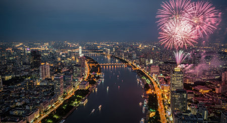 Aerial view of Bangkok at night with fireworks illuminating the Chao Phraya River, showcasing the city's vibrant skyline and festive atmosphere.の素材
