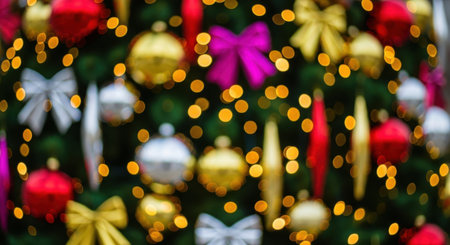 Defocused Christmas tree with colorful ornaments and glowing bokeh lights creating a magical and festive holiday background for New Year or Christmas celebrations.の素材