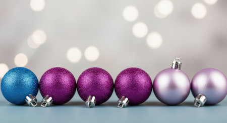 A row of colorful Christmas ornaments, perfect for holiday decorations and festive celebrations. The ornaments are arranged in a line, showcasing their vibrant colors and shiny surfaces.の素材