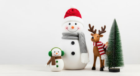 A cheerful arrangement of Christmas decorations featuring a snowman, a reindeer, and a small Christmas tree, perfect for holiday greetings and festive designs.の素材