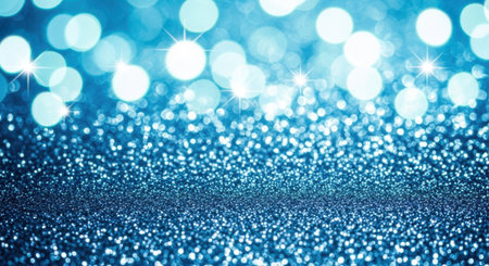Close up of sparkling blue glitter dust with a beautiful out of focus bokeh light background. Festive and magical concept for Christmas or party invitations.の素材
