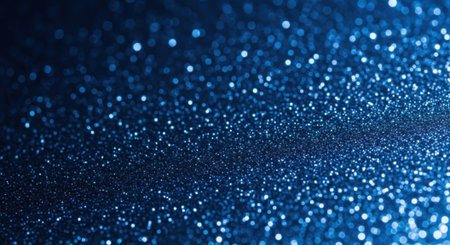 A macro shot of shimmering blue glitter creating a beautiful abstract texture. The defocused lights produce a magical bokeh effect, perfect for festive or elegant backgrounds.の素材