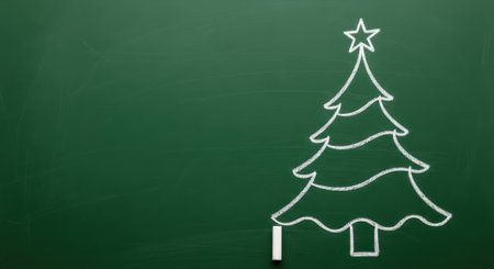 A simple white chalk drawing of a Christmas tree with a star on top, set against a plain green chalkboard background.の素材