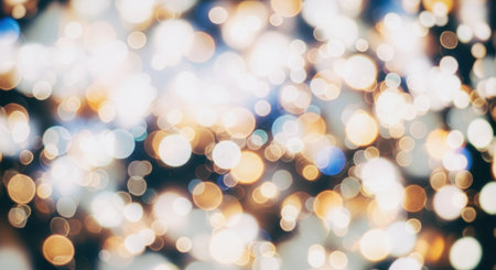 A beautiful abstract background featuring soft, out of focus circular lights in warm golden, white, and blue tones. This creates a magical and festive bokeh effect.の素材