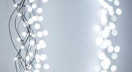 A minimalist image featuring a string of white lights against a soft gray backdrop, perfect for adding a touch of elegance to any design.の素材