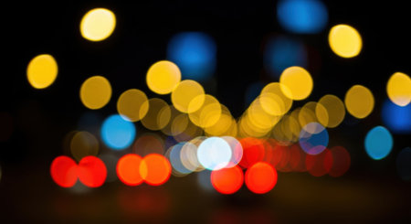 A captivating display of out-of-focus lights, forming a beautiful bokeh effect against a dark background, perfect for abstract and atmospheric designs.の素材