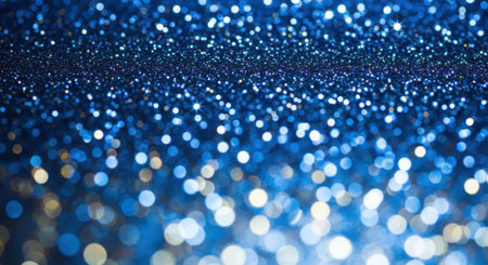 Close-up of a shimmering blue glitter background with a beautiful bokeh effect, perfect for holiday and celebratory designs.の素材
