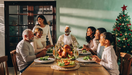 A warm and joyful scene of a diverse family celebrating Christmas with a traditional holiday meal, complete with a roasted turkey and a decorated tree.の素材