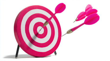 A vibrant image of a pink dartboard with darts, one hitting the bullseye and others in flight, symbolizing accuracy and success.の素材