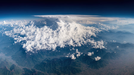 A breathtaking aerial view of a massive cumulonimbus cloud system, showcasing its immense scale and intricate structure from the edge of space.の素材