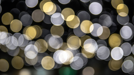 A beautiful abstract background featuring out-of-focus bokeh lights in various warm and cool tones, creating a dreamy and festive atmosphere.の素材