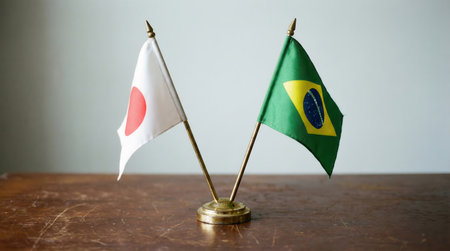 the image features the flags of japan and brazil displayed on a wooden table symbolizing international relations and cooperation between nationsの素材