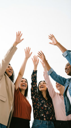 Group of happy business people raising their hands in the air with a white backgroundの素材