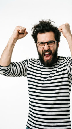 Excited bearded man with glasses and a striped shirt showing his musclesの素材