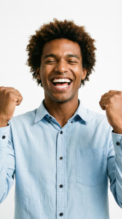 Portrait of a happy African American man celebrating success isolated on a white backgroundの素材