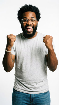 Portrait of a happy African American man celebrating success isolated on a white backgroundの素材