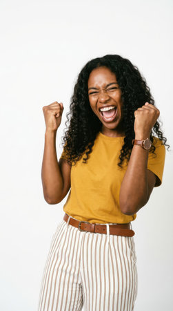 Portrait of a happy young African American woman celebrating successの素材