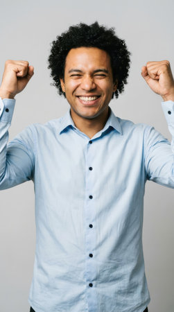 Portrait of a young african american businessman showing his musclesの素材