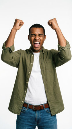 Portrait of a happy young african american man celebrating success isolated over white backgroundの素材