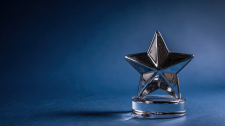 A close-up shot of a shiny star trophy with a blue gradient background, symbolizing achievement and success.の素材