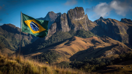 The vibrant Brazilian flag flutters against a backdrop of rugged, sun-drenched mountains, showcasing national pride in a stunning natural setting.の素材