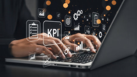 Hands of businesswoman typing on laptop keyboard with business icons and symbolsの素材