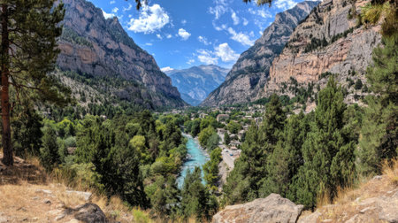 A stunning panoramic vista from a high viewpoint, looking down into a deep canyon where a vibrant turquoise river winds through a dense pine forest under a blue sky.の素材