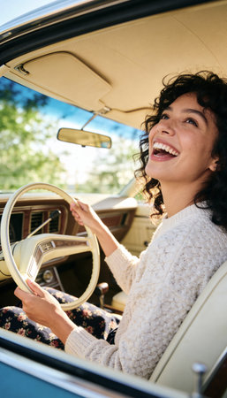 A beautiful, cheerful woman enjoys a scenic drive in her retro automobile, smiling with happiness and freedom on a bright, sunny summer day. A portrait of pure joy and leisure.の素材