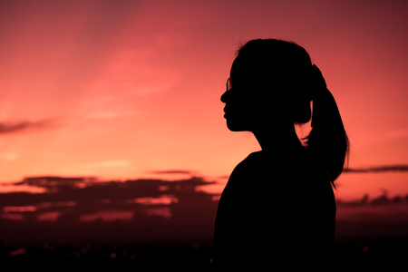 Silhouette of lady and twilight.の写真素材