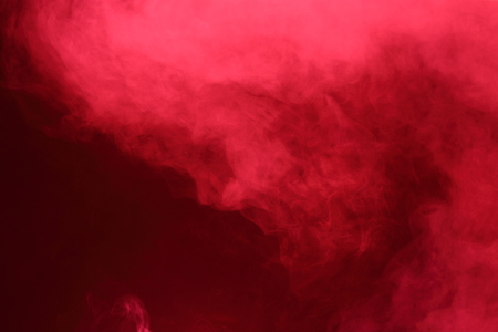 Red Dense Fluffy Puffs of White Smoke and Fog on Black Background, Abstract Smoke Clouds, All Movement Blurred, intention out of focus, and high low exposure contrast, copy space for text logoの写真素材