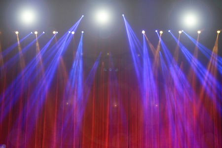 Performance moving lighting on construction light beam ray downward in yellow blue color, on Concert and Fashion Show stage rampの写真素材