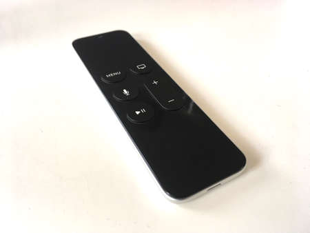 Black Smart Remote Control Sat On White Tableの写真素材