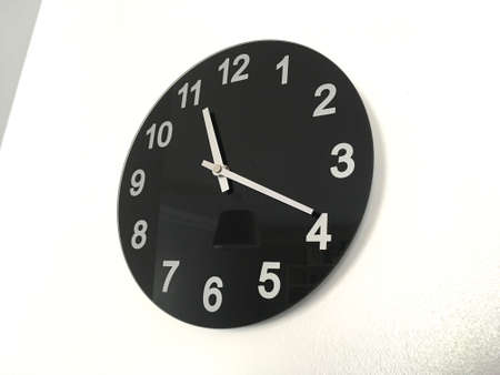 Simple Black Clock Hung On White Wallの写真素材