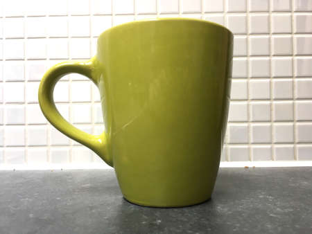 Blue Mug Against White Tiled Wallの写真素材