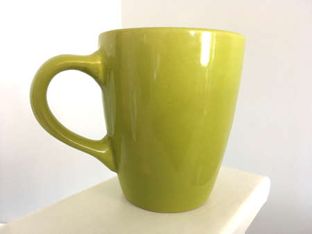 Green Mug Against Pale Grey Backgroundの写真素材