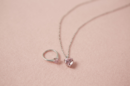 Ring and pendant on pink backgroundの写真素材