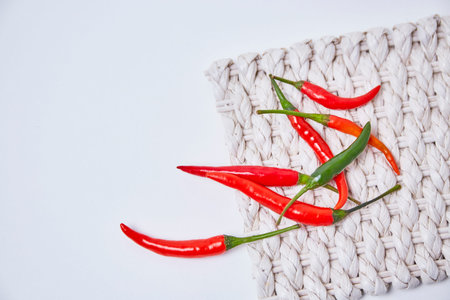 Chili on thatch on white background