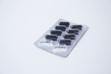 Black drug capsule in packageの写真素材