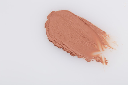 Smudged beige lipstick on white backgroundの写真素材