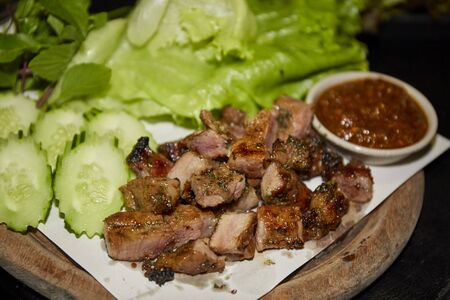 Sliced grilled beef on wooden plateの写真素材