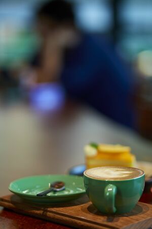 Colorful cup of coffee on wooden tableの写真素材