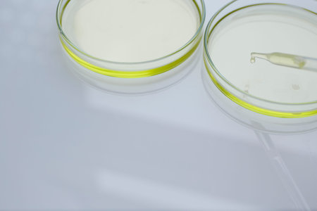 Pipette and pure essential oil in petri dishの写真素材