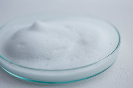 White cosmetics foam in petri dish