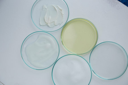 Cosmetics cream, foam and essential oil in petri dish