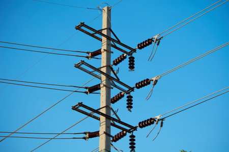 Electricity post with blue sky background, power transmission lines and wires