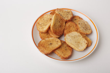 Toasted bread on a plate on a white background, top viewの写真素材