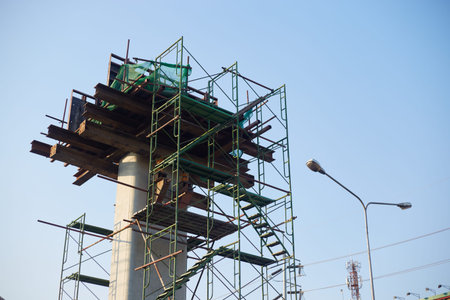 Construction of a high-rise building with scaffolding and crane